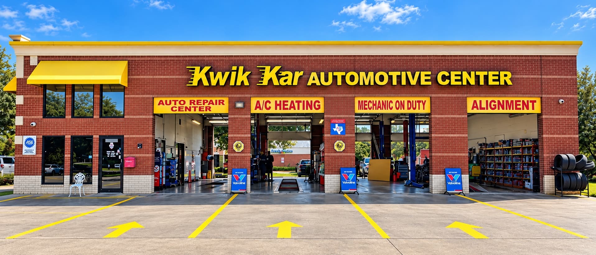 Kwik Kar Automotive Center storefront with open service bays